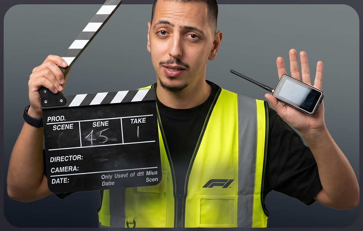 Wael Fahed in a safety vest holding a clapperboard and a wireless field monitor