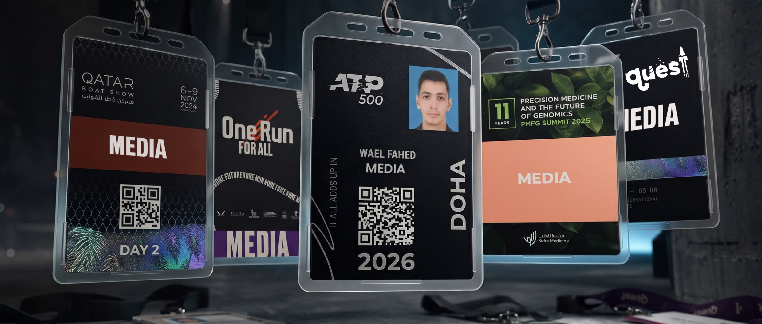 Five media accreditation badges on lanyards: Qatar Boat Show 2024, One Run For All, ATP 500 Doha 2026, Sidra Medicine PMFG Summit 2025, and a press badge